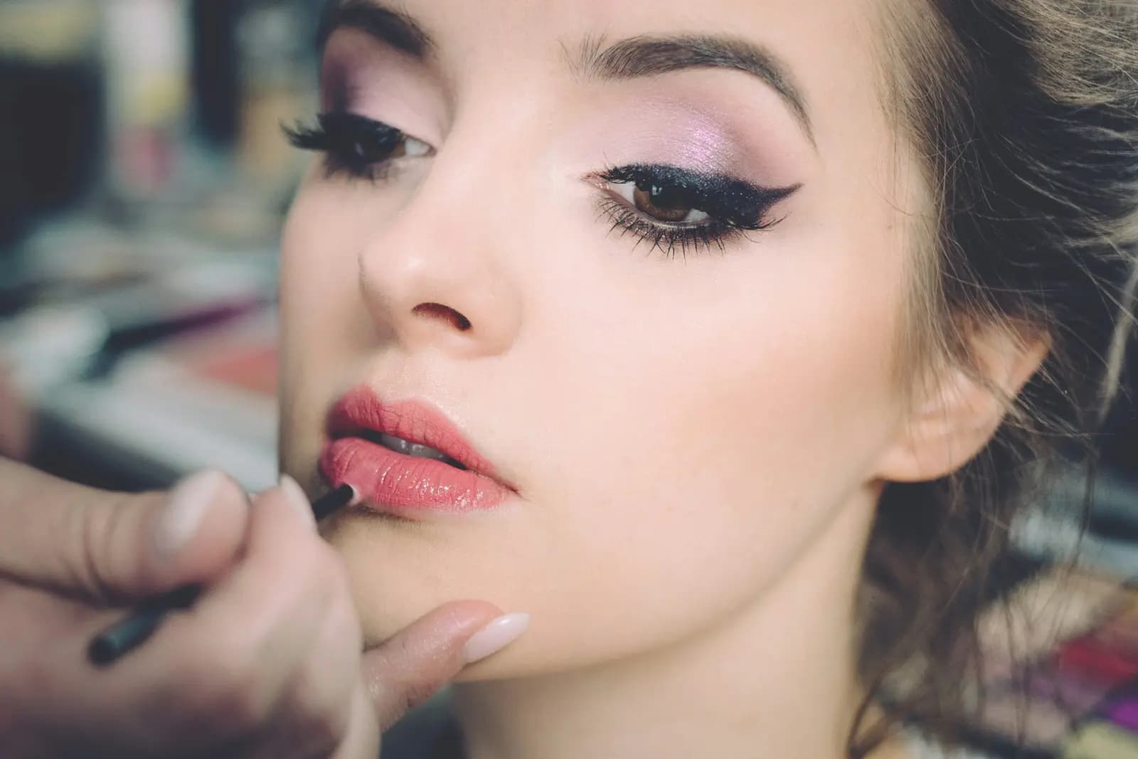 Makeup artist preparing a client for an event