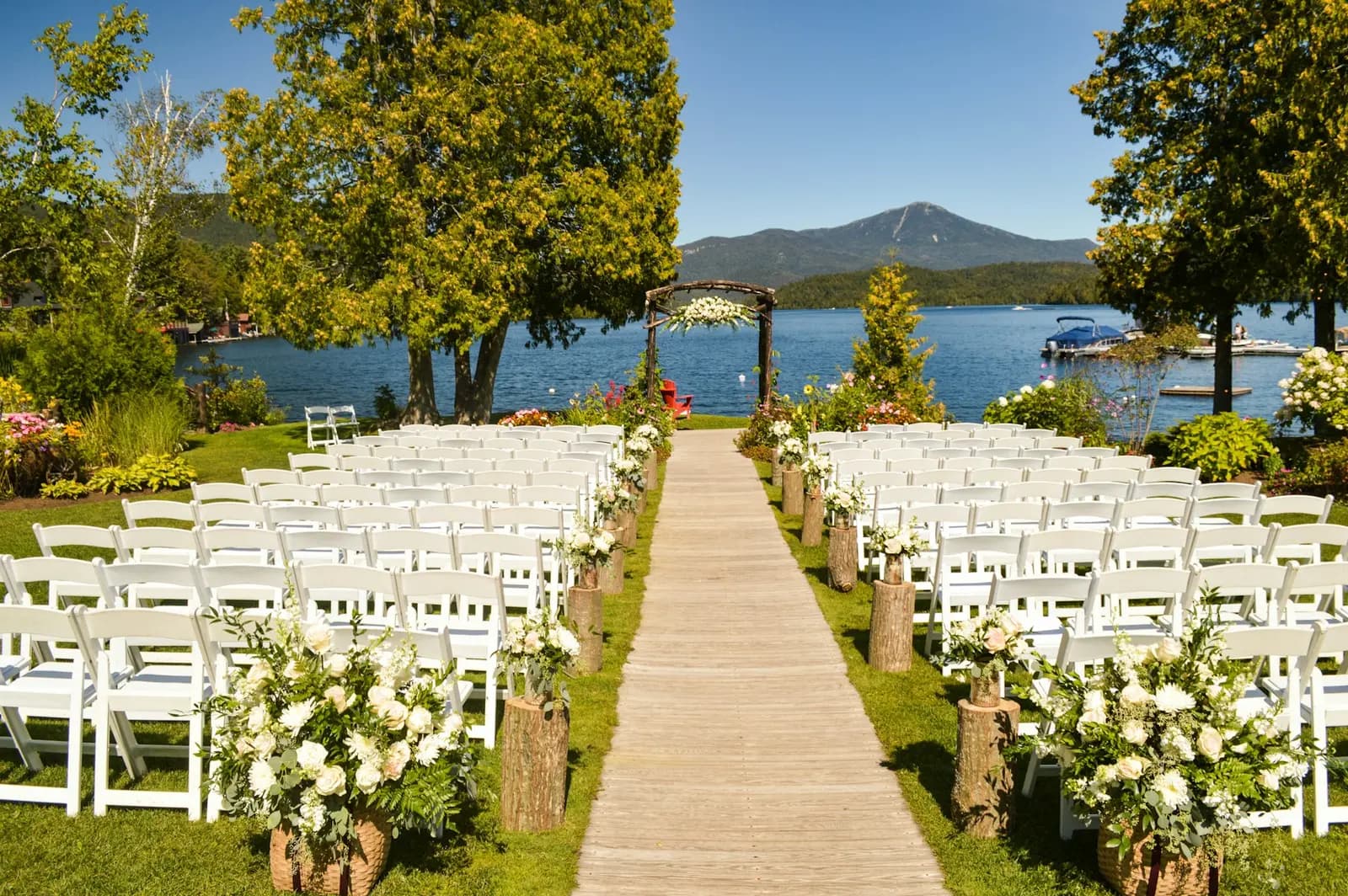 Ceremony seating arranged beside a lakeside pavilion